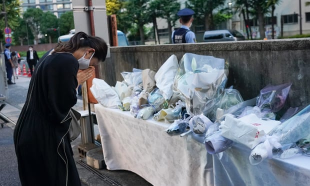 A mourner on Sunday at the entrance of the Liberal Democratic party headquarters in Tokyo.