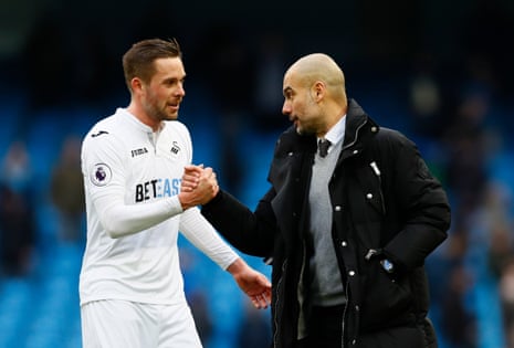 Guardiola shakes hands with Swansea goalscorer Gylfi Sigurdsson after the final whistle.