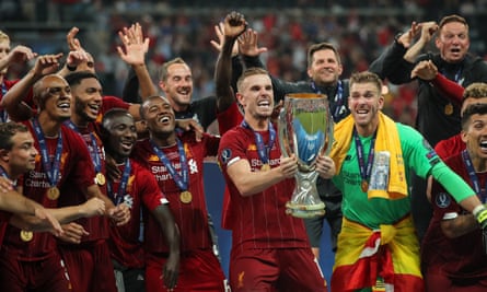 Jordan Henderson lifts the trophy surrounded by delighted teammates