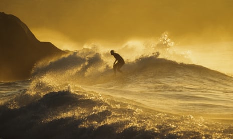 A man surfing on the ocean.