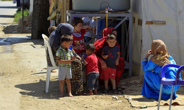 Syrian mothers and children at a refugee camp in the eastern Lebanese town of Saadnayel.