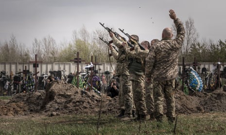 Ukrainian soldiers take part in a funeral service in Bucha. 