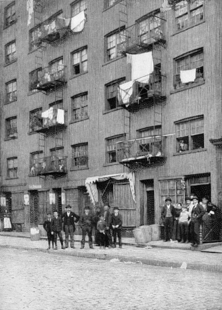 Boys congregate outside a tenement building