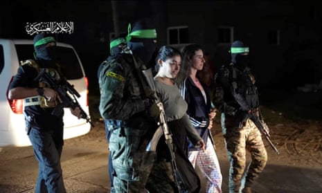 Hamas fighters hand over hostages to the International Red Cross in Gaza