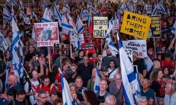 People holding placards at a protest in Tel Aviv
