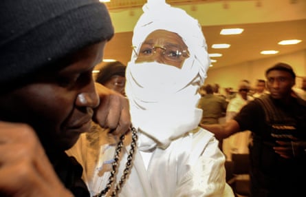 Hissène Habré reacts as he is escorted in to stand trial by police at the Palais de Justice in Dakar, Senegal.