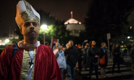 A protester dressed as bishop in a night-time march