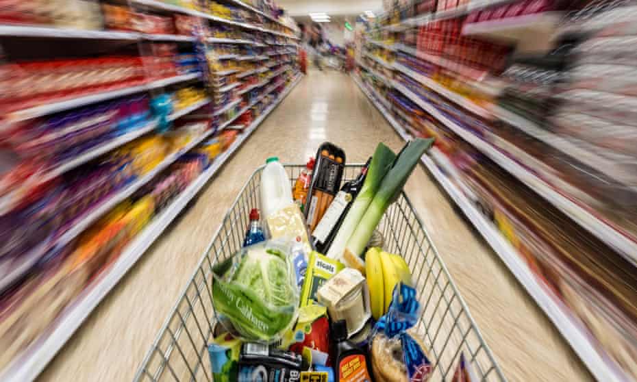 a shopping trolley full of food goods in a supermarket