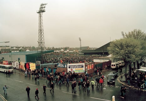 Some of the crowd leave the Goldstone Ground while others remain on the pitch after the last game at the ground