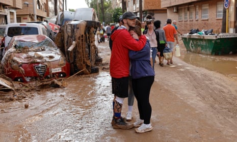 Residents comfort each other in Paiporta