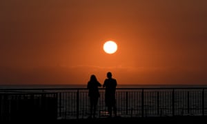 red sun rises over the sea