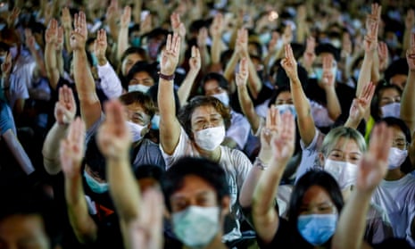 Pro-democracy demonstrators raise a three-finger salute – a gesture taken from film the Hunger Games – during a rally in Bangkok, Thailand, on Sunday.