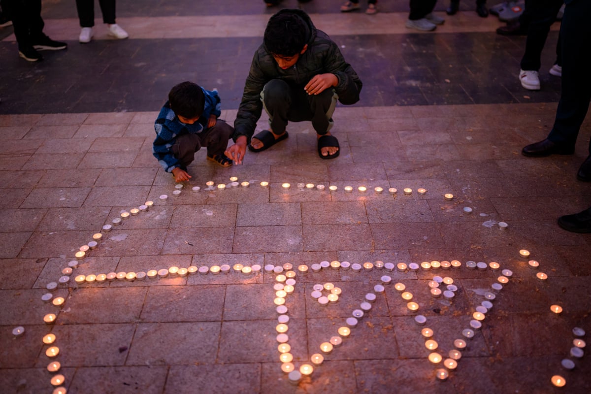 Candles arranged in the shape of the Nepali flag at prayers in Rockdale
