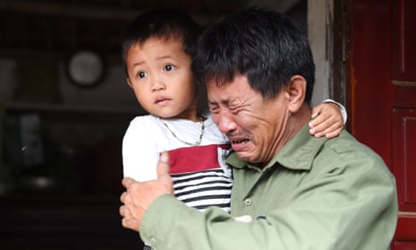 Le Minh Tuan, the father of 30-year-old Le Van Ha, who is feared to be among the 39 people found dead in a lorry in Essex, holds Ha’s five-year-old son.