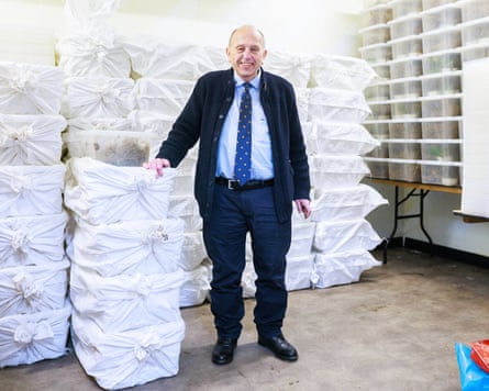 Ball stands in a refrigerator with boxes of snails ready for dispatch.