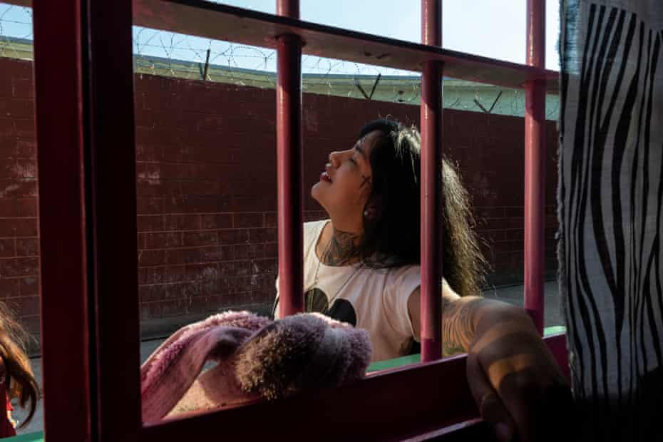 Yamila, 22, sunbathes on the patio of her detention center