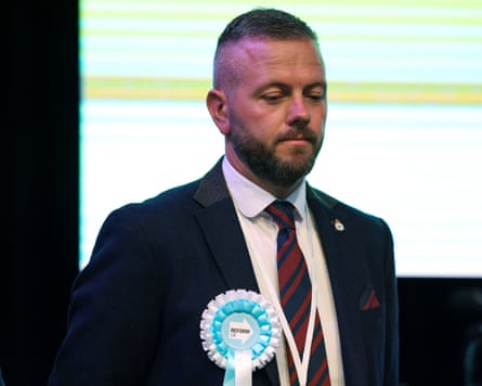 Robert Kenyon on stage after the byelection result wearing a Reform rosette