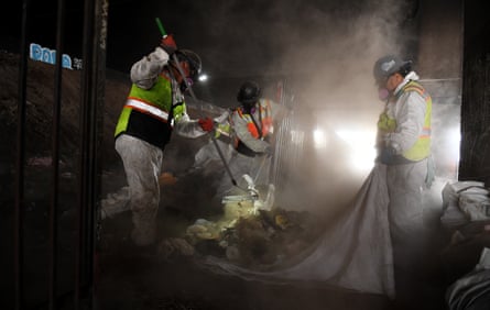 Crews remove personal belongings at an encampment under the 405 freeway in Inglewood, California, on 25 January 2022, in preparation for the Super Bowl.