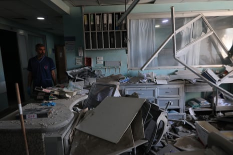 A medical worker looks at the damage inside Jabal Amel hospital.