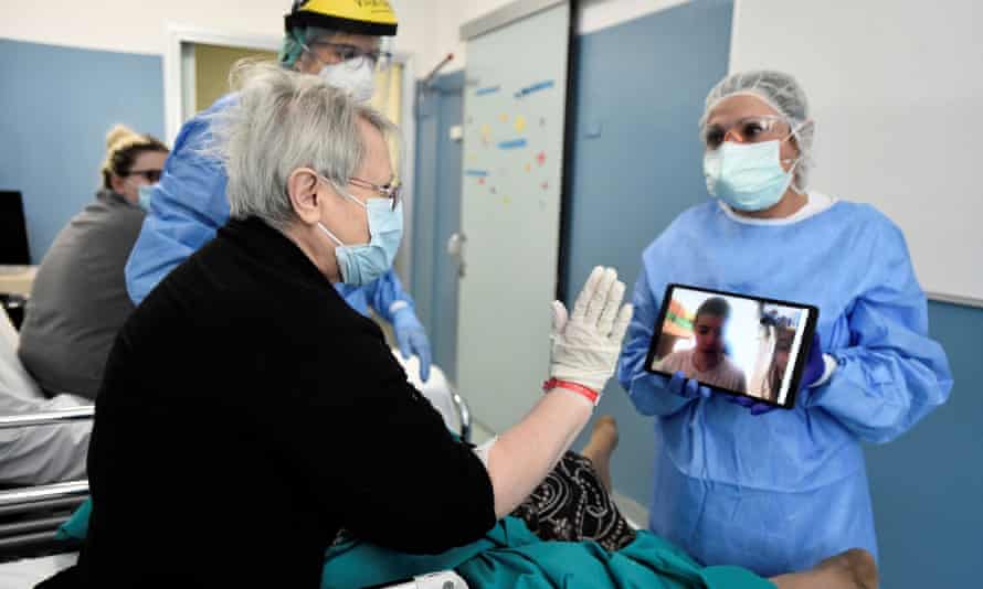 A Covid-19 patient uses a tablet to speak to a relative who is unable to visit, in Milan, Italy.