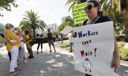 A small group of demonstrators gathers at Lake Eola Park to protest against the Florida unemployment benefits system in June in Orlando.