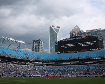 Storm clouds gather over the Bank of America Stadium in Charlotte, as screens tell fans and players the match is suspended