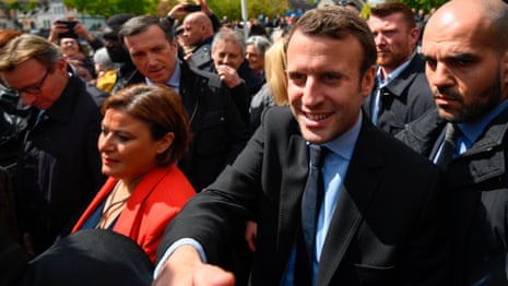 Macron shakes hands with workers as he leaves