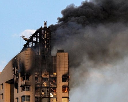 Smoke rises from a burning high-rise building