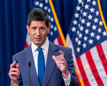 Kevin Warsh pictured in front of US flags in the Fed building