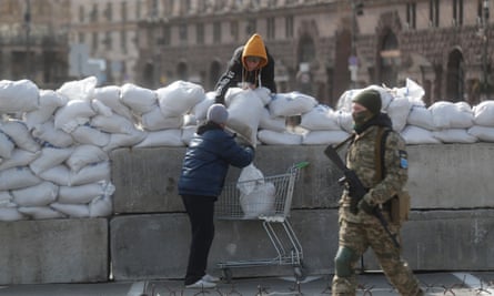 People set up a barrier of sandbags in downtown Kyiv
