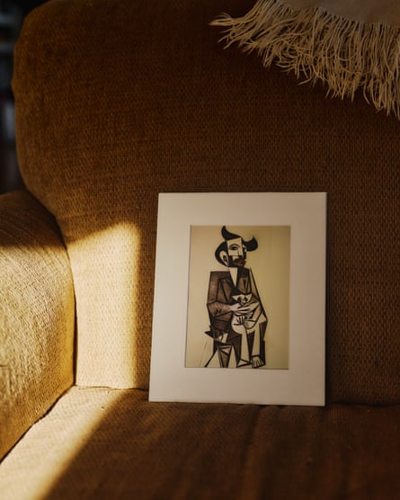 A printed picasso-like AI generated drawing resting on a chair