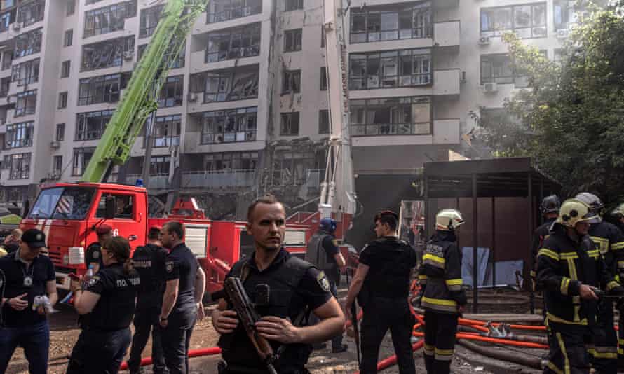 Police and firefighters at a damaged residential building in the Shevchenkivskyi district of Kyiv.