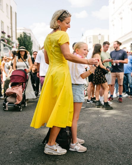 A mother and daughter share a moment dancing together.