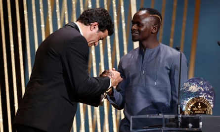 Sadio Mané receives the Socrates Prize from the late Brazilian's brother, Rai.