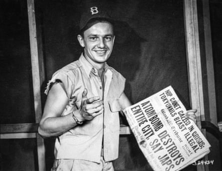 Bob Caron with a newspaper headlining the Hiroshima attack.