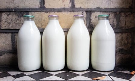 Four milk bottles on a doorstep