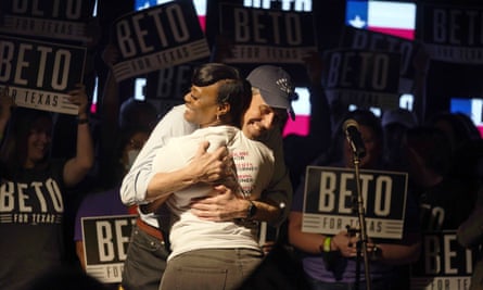 Woman hugs man at political rally