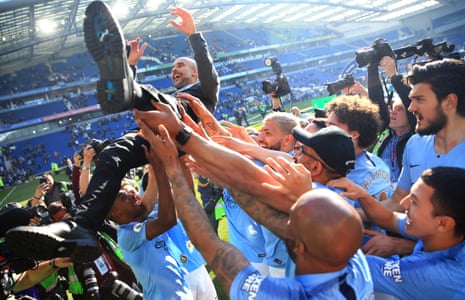 May 12: Manchester City players throw Pep Guardiola in the air as they celebrate winning the Premier League.