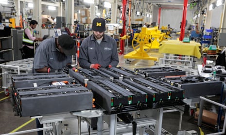 Technicians work on battery packs at a manufacturing site in Livonia, Michigan.