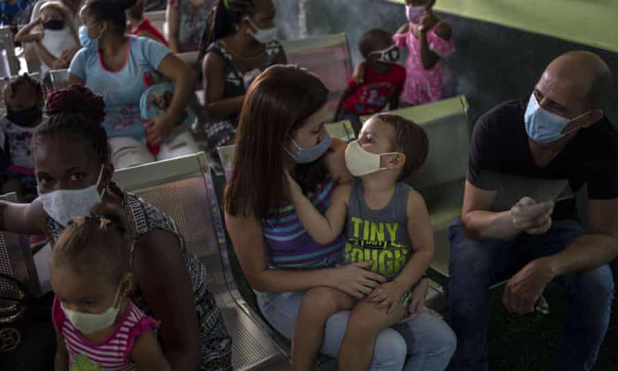 Parents wait to have their children vaccinated with the Soberana-02 Covid-19 vaccine, at a clinic in Havana in September 2021.