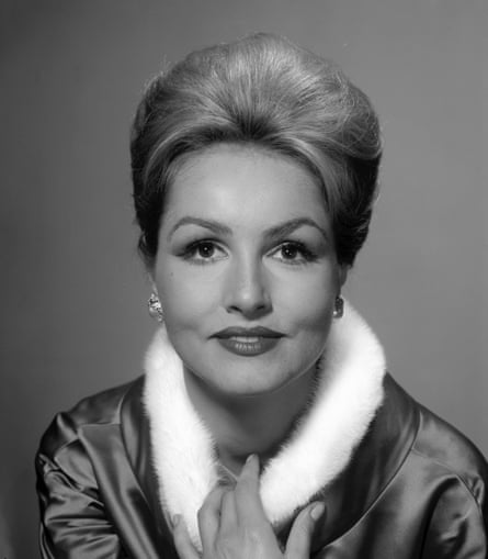 A black and white portrait of a blonde, attractive woman with bouffant hair.
