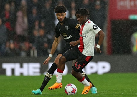 Romeo Lavia vies with Bournemouth's Danish midfielder Philip Billing in a very wet Southampton.