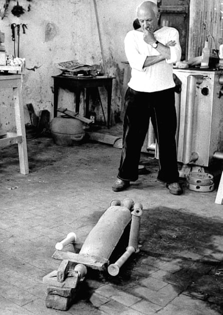 At work … Picasso studies the figure of a woman he assembled on the floor of his studio at Vallauris, southern France, in 1953.