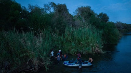 Migrant families enter the Unites States after being smuggled across the Rio Grande river from Mexico into Roma, Texas, on 26 August.