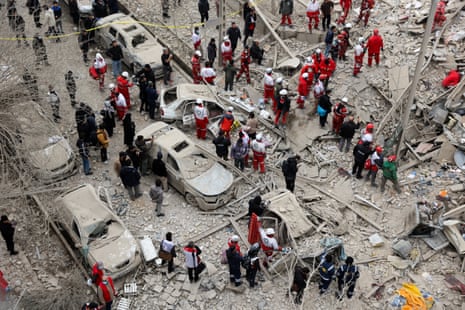 Emergency personnel work at the site of an Israeli airstrike on a residential building, in Tehran, Iran, on 16 March 2026.