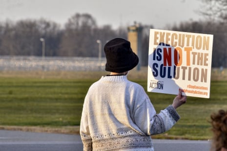 a protester holds a sign that reads "execution is not the solution"