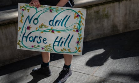 Person with placard reading ‘no drill Horse Hill’