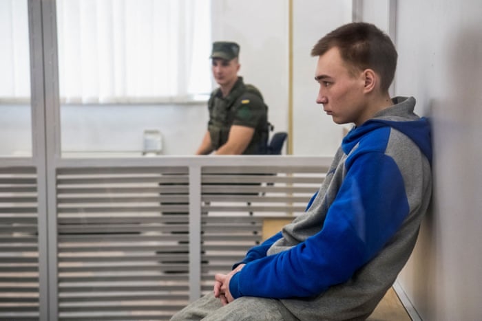 Russian soldier Vadim Shishimarin, 21, sits inside a glass cage during the appeal court hearing in Kyiv on 25 July