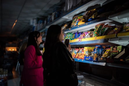 People shop for groceries using their phone aduring a widespread power outage