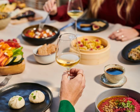 People around a table enjoying sherry and tapas